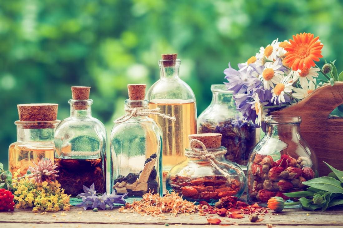 A table with some jars and flowers on it