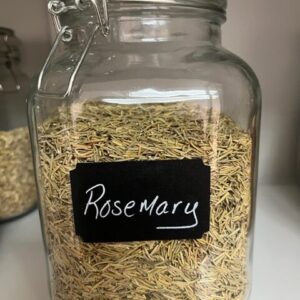 Glass jar filled with dried rosemary.