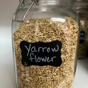 Jar labeled "Yarrow flower" with dried herbs.