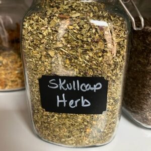 Jar labeled "Skullcap Herb" with dried herbs.