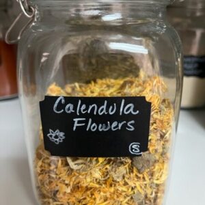 Jar of dried calendula flowers.