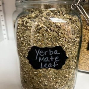 Jar of dried yerba mate leaves.