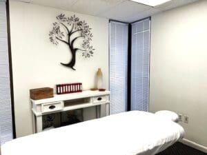 Massage room with white walls and a massage table.